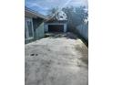 Large driveway with access to a detached garage, ideal for additional parking or storage at 507 Danube Ave, Tampa, FL 33606