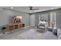Cozy living room featuring neutral tones, tile floors, ceiling fan, and natural light at 6601 121St Ave # I, Largo, FL 33773
