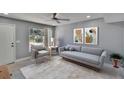Comfortable living room with modern furnishings, soft rug, and lots of natural light at 6601 121St Ave # I, Largo, FL 33773