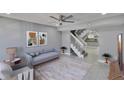 Open-concept living area with staircase, comfortable seating, and view of the kitchen at 6601 121St Ave # I, Largo, FL 33773