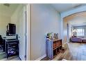 Hallway with hardwood floors, neutral paint, and storage shelves leading into the living space at 6648 Castle Green Pl, Zephyrhills, FL 33541
