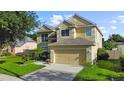 Charming two-story home with a manicured lawn and a two-car garage, surrounded by lush trees at 7711 Nottinghill Sky Dr, Apollo Beach, FL 33572
