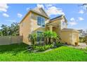 Beautiful two-story home with vibrant landscaping, lush green lawn, and a welcoming, sunny facade at 7711 Nottinghill Sky Dr, Apollo Beach, FL 33572