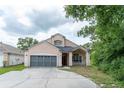 Inviting two-story home with a spacious two-car garage and welcoming front porch at 8050 Diablo Ct, Trinity, FL 34655