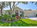 Beautiful single-story home boasting a lush lawn, mature shade trees, and a convenient two-car garage at 8213 Swann Hollow Dr, Tampa, FL 33647
