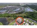 An aerial view of the home highlighting its location in a desirable community with lakes at 8515 Hunters Fork Loop, Ruskin, FL 33573