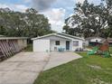 Single-story home with a well-kept lawn and a play set at 8701 N Packwood Ave, Tampa, FL 33604