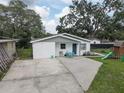Single-story home with a well-kept lawn and a play set at 8701 N Packwood Ave, Tampa, FL 33604