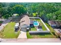 An aerial view shows a private backyard pool, RV parking and manicured lawn in a fenced yard at 901 Strawberry Ln, Brandon, FL 33511