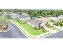 An elevated street view captures a well-maintained home with manicured lawn and landscaping, within a lush green neighborhood at 9067 39Th Street E Cir, Parrish, FL 34219