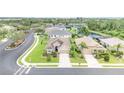 An aerial view showcases a lovely home in a neighborhood near a scenic pond surrounded by lush greenery at 9067 39Th Street E Cir, Parrish, FL 34219