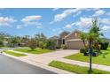 Beautiful single-story home with a well-manicured lawn and lush landscaping in a suburban neighborhood at 9067 39Th Street E Cir, Parrish, FL 34219