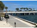 Scenic boardwalk along the water, featuring palm trees and a golf cart, capturing a tranquil and inviting atmosphere at 1137 Highland S St, St Petersburg, FL 33701