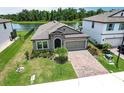 Charming single-story home featuring a brick driveway and a well-manicured front lawn at 12646 Oak Hill Way, Parrish, FL 34219