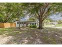 Spacious front yard with large trees adding natural charm to this single-story home at 1608 Carlos Ave, Clearwater, FL 33755