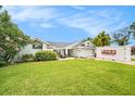 Inviting single-story home with lush lawn, landscape, neutral paint, and ample space for outdoor entertaining at 1763 Pebble Hill Ct, Palm Harbor, FL 34683