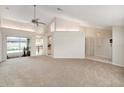 Neutral living room with plush carpeting, bright light, airy open floor plan, and access to outdoor pool at 1763 Pebble Hill Ct, Palm Harbor, FL 34683