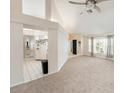 Neutral living room with plush carpeting, bright light, airy open floor plan, and ceiling fan at 1763 Pebble Hill Ct, Palm Harbor, FL 34683