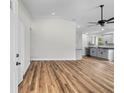 Spacious living room featuring an open floor plan and sleek, modern flooring at 19267 Wildwood Dr, Brooksville, FL 34601