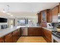 Stylish kitchen featuring stainless steel appliances, wood cabinets, and a breakfast bar, perfect for entertaining at 218 N Bay Hills Blvd, Safety Harbor, FL 34695