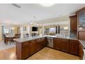 A view of the open kitchen featuring sleek appliances, ample cabinetry, and an island prep space at 218 N Bay Hills Blvd, Safety Harbor, FL 34695