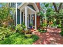 Inviting entrance with brick walkway, lush landscaping, and outdoor seating area at 2404 W Jetton Ave, Tampa, FL 33629