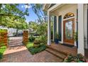Charming home entrance with brick walkway, beautiful front door and well-manicured landscaping at 2404 W Jetton Ave, Tampa, FL 33629