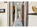 Inviting entryway with wood-look floors, stairs to the second floor and a view to the lanai at 2700 Bayshore Blvd # 544, Dunedin, FL 34698