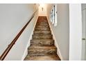 Staircase with wood-look steps leading to the upper level of the home at 2700 Bayshore Blvd # 544, Dunedin, FL 34698