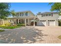 Beautiful exterior view of a two-story house with a large front porch and a two-car garage at 2803 W Morrison Ave, Tampa, FL 33629