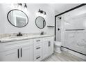 Elegant bathroom featuring double sinks, granite countertops, and a glass-enclosed shower at 2859 38Th N Ave, St Petersburg, FL 33713