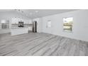 Bright and open living room showcasing wood floors and white walls with kitchen in view at 2859 38Th N Ave, St Petersburg, FL 33713
