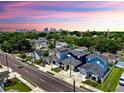 Aerial view of neighborhood with colorful homes, tree lined streets, and city skyline at 2918 N 21St St, Tampa, FL 33605