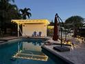 Backyard pool featuring a covered patio, a tranquil setting and charming string lights at 3012 Grand View Ave, Clearwater, FL 33759