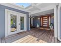 Inviting front porch with wood floors, double doors and a contemporary wood front door at 3012 Grand View Ave, Clearwater, FL 33759