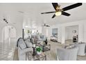 Bright living room with neutral walls, plush seating, and large ceiling fans, creating an inviting and airy atmosphere at 304 Westwinds Dr, Palm Harbor, FL 34683