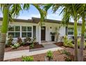 Charming front entrance with lush landscaping and a well-manicured lawn at 309 Palmetto Ln, Largo, FL 33770