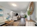 Bright living room boasts stylish decor, wood floors, and plenty of space for entertaining at 3111 W Douglas St, Tampa, FL 33607