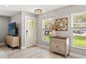 Bright entryway featuring stylish console table, modern decor, and a view of the lush front yard at 3135 W Varn Ave, Tampa, FL 33611