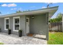 Close-up of front entrance, showing the address, stylish light fixture, and freshly painted facade at 3135 W Varn Ave, Tampa, FL 33611