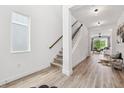 Bright foyer with hardwood floors and staircase leading to the upper level at 315 Blackrock Ln, Apollo Beach, FL 33572