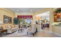 Inviting living room with elegant furnishings and ample natural light from a large window at 33744 Americana Ave, Dade City, FL 33525