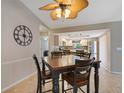 Cozy dining area with stylish furnishings, seamlessly connecting to an open kitchen design at 37147 Foxrun Pl, Zephyrhills, FL 33542