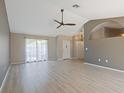 Bright and airy living room featuring vaulted ceilings, neutral paint, and elegant flooring at 37147 Foxrun Pl, Zephyrhills, FL 33542