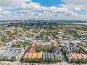 Wide aerial shot showcasing neighborhood, nearby lake, and vibrant cityscape under a sunny, cloudy sky at 410 S Armenia Ave # 926, Tampa, FL 33609