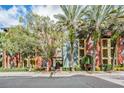 The colorful exterior of the building stands out with palm trees and landscaping at 410 S Armenia Ave # 926, Tampa, FL 33609