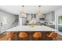 A spacious kitchen island with seating and modern light fixtures and stainless steel appliances at 4521 S Cooper Pl, Tampa, FL 33611