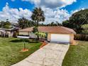 Charming single-story home with well-maintained lawn, mature landscaping, and a spacious two-car garage at 5004 S Hesperides St, Tampa, FL 33611