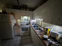 This kitchen features classic white cabinets and appliances, ready for a modern update at 6817 S Wall St, Tampa, FL 33616