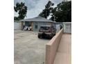 Exterior view of a home, showcasing its driveway, muted color scheme and proximity to additional parking at 7022 Hubert, Tampa, FL 33614